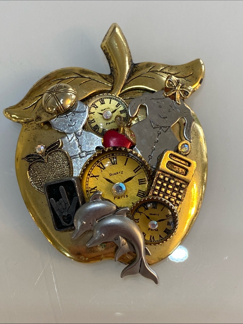 Gold-Tone Apple Collage Brooch with Clock Faces and Dolphin Accents